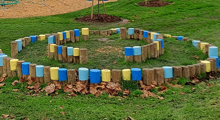 Crossfield Reserve - Circle of coloured logs for stepping and balancing.