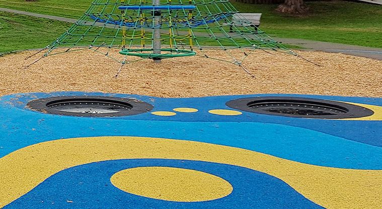 Crossfield Reserve - In-ground trampolines with brightly coloured soft-fall surrounds.