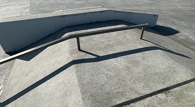 David Lange Park - Section of the skate park with a ramp, rail, and ledge.