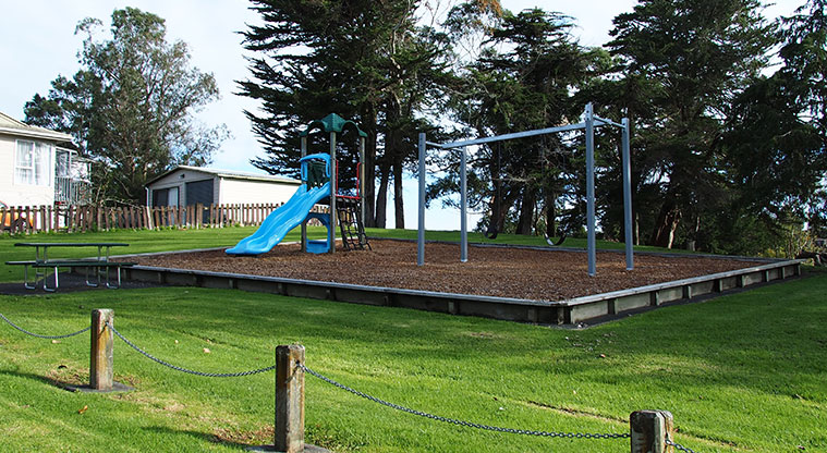 Kahikatea / Gallony Park - Playground for younger children with climbing net, ladder, two slides and two swings. Photo credit: Tracey Hodder.