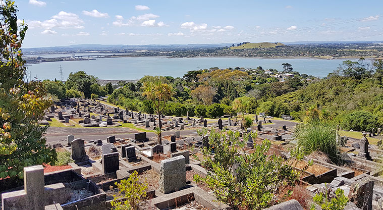 Hillsborough Cemetery – looking out over a section of the cemetery with the Manukau Harbour in the background.