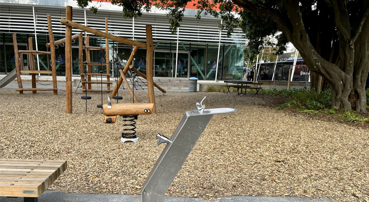 Jack Pringle Village Green - Drinking fountain next to a park bench by the playground. Photo credit: Keren Alleyne.
