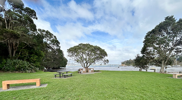 Wai Manawa / Little Shoal Bay Reserve - Picnic table, seating and a barbecue with Little Shoal Bay in the background. Photo credit: S Hulse.