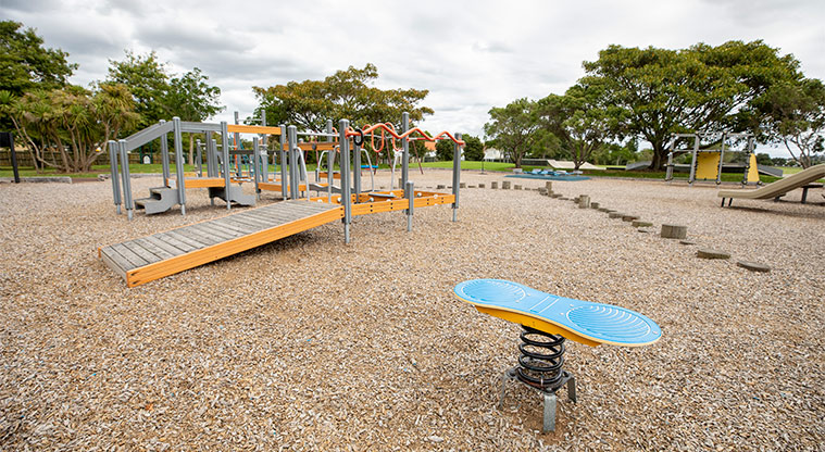 May Road War Memorial Park - Playground with bouncy toys, ramps, climbing equipment, and swings.