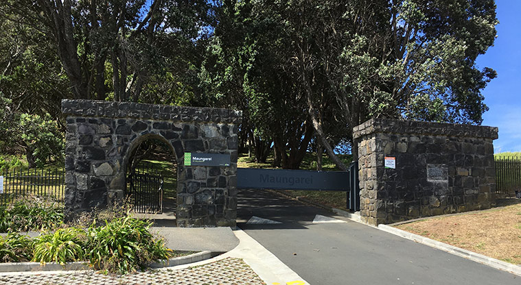 Maungarei / Mount Wellington Domain - Brick entrance to the domain with the road and trees in the background.