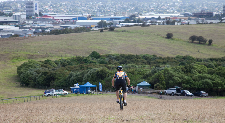 Mutukāroa / Hamlins Hill Regional Park - Riding down hill looking west.