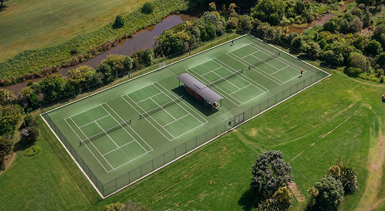 Onetangi Sports Park - Aerial view of the tennis courts and surround park land.