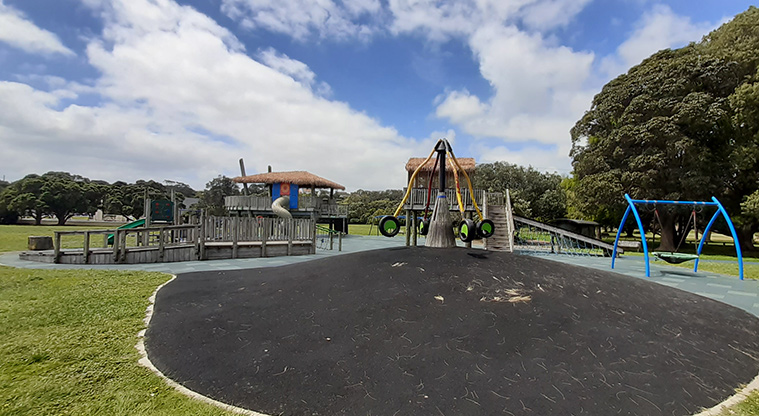 Ōrākei Domain - The rocktopus at the top of a mound, the basket swing, and the rest of the playground in the background.