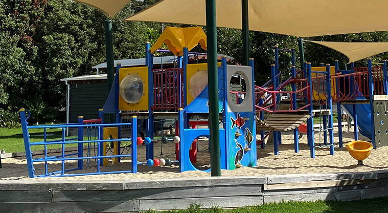 Palm Beach Reserve -Boat shaped play area with a sand base, climbing equipment, swings, slides, spinning egg cup, and more. Shade sails cover the main play area. Photo credit: T Hodder.