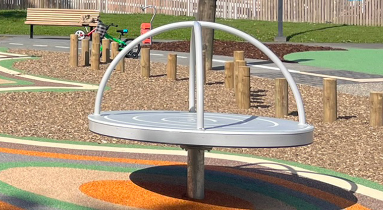 Shepherds Park - Spinning carousel with balance poles in the background.